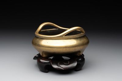 A Chinese bronze tripod censer on a wooden stand, Song Zhu Xuan 松竹軒 mark, 18th C.