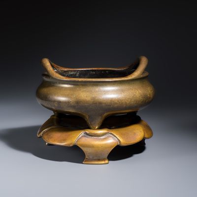 A Chinese bronze tripod censer with handles and stand, Xuande mark, 18th C.