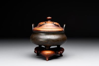 A Chinese bronze tripod censer with wooden cover and stand, Xuande mark, 18/19th C.