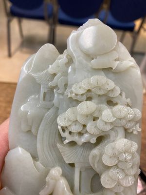 A Chinese brown jade inscribed seal stamp and a white jade 'mountainous landscape' carving, 19/20th C. — photo 16