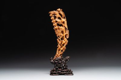 A Chinese buffalo horn carving of a landscape with a pagoda on wooden stand, Qing