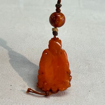 A Chinese carved amber pendant of a Bodhisattva — photo 3
