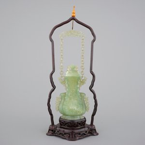 A Chinese carved green jadeite vase and cover on elaborate wooden stand, 19/20th C. — photo 1