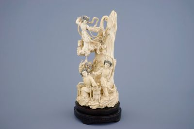 A Chinese carved ivory group of the moon goddess and 2 girls on a wooden base, 19/20th C.