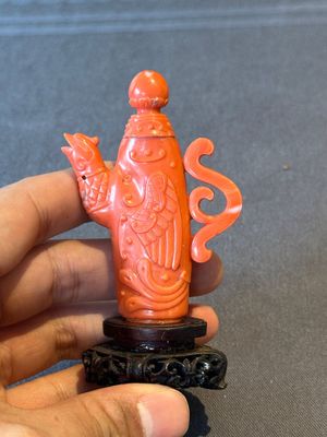 A Chinese carved red coral ewer and cover on wooden stand, 19th C. — photo 1