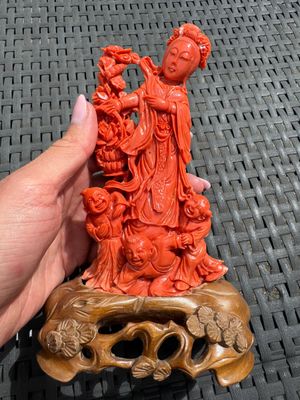 A Chinese carved red coral 'Goddess and Boys' group on a wooden stand, 19/20th C. — photo 1