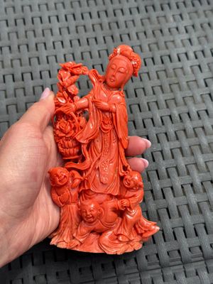 A Chinese carved red coral 'Goddess and Boys' group on a wooden stand, 19/20th C. — photo 3
