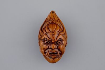 A Chinese carved walnut, signed, 20th C.
