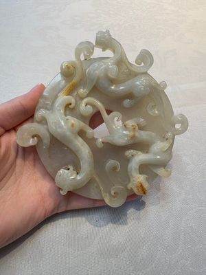 A Chinese carved white and russet jade bi-disc with chilong design, 19/20th C. — photo 1
