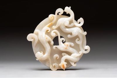 A Chinese carved white and russet jade bi-disc with chilong design, 19/20th C.