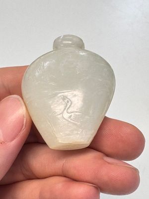 A Chinese carved white jade 'Geese' snuff bottle on a wooden stand — photo 11
