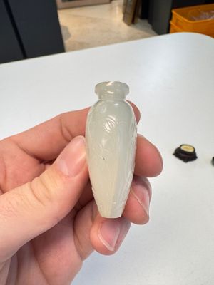 A Chinese carved white jade 'Geese' snuff bottle on a wooden stand — photo 13