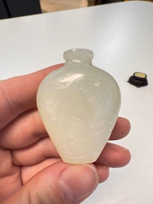 A Chinese carved white jade 'Geese' snuff bottle on a wooden stand — photo 2