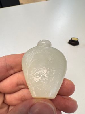 A Chinese carved white jade 'Geese' snuff bottle on a wooden stand — photo 3