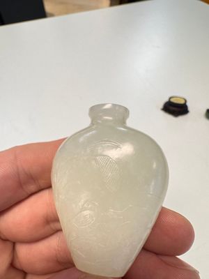 A Chinese carved white jade 'Geese' snuff bottle on a wooden stand — photo 4