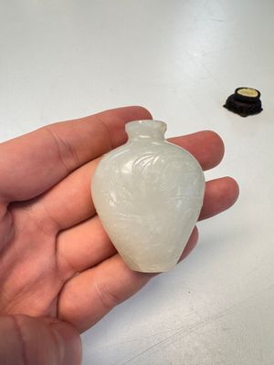 A Chinese carved white jade 'Geese' snuff bottle on a wooden stand — photo 7