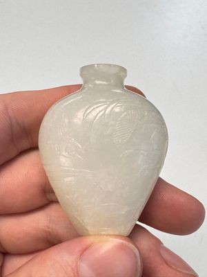 A Chinese carved white jade 'Geese' snuff bottle on a wooden stand — photo 9