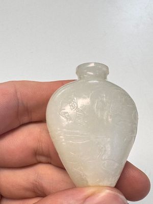 A Chinese carved white jade 'Geese' snuff bottle on a wooden stand — photo 10