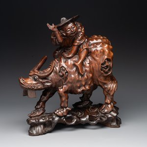 A Chinese carved wooden group of a boy riding a water buffalo, 20th C. — photo 1