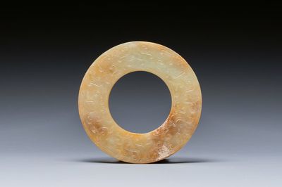 A Chinese celadon and russet jade 'bi' disc, probably Han — photo 1