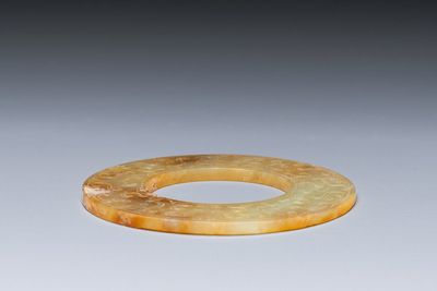 A Chinese celadon and russet jade 'bi' disc, probably Han — photo 3