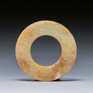 A Chinese celadon and russet jade 'bi' disc, probably Han — photo 1