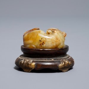 A Chinese celadon and russet jade carving of a tiger, Ming — photo 11