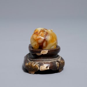 A Chinese celadon and russet jade carving of a tiger, Ming — photo 12