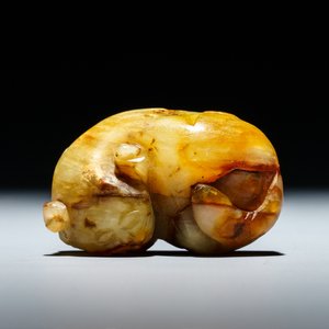 A Chinese celadon and russet jade carving of a tiger, Ming — photo 8