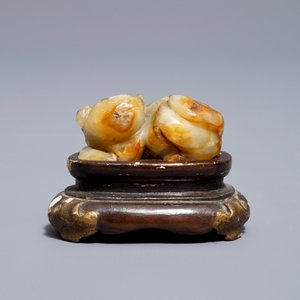 A Chinese celadon and russet jade carving of a tiger, Ming — photo 9