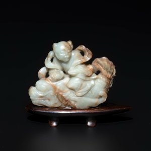 A Chinese celadon and russet jade figure of a boy riding a dragon carp, Qing — photo 2