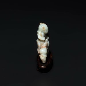 A Chinese celadon and russet jade figure of a boy riding a dragon carp, Qing — photo 3