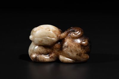A Chinese celadon and russet jade mythical beast carving, Ming