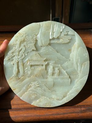 A Chinese celadon and russet jade plaque with landscape design, 19th C. — photo 1