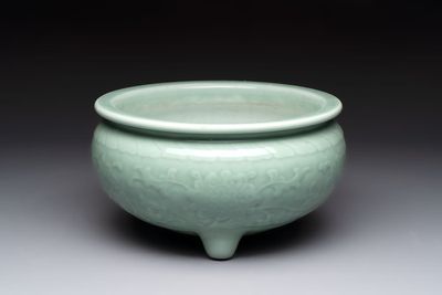A Chinese celadon-glazed tripod censer with floral anhua design, 18/19th C.