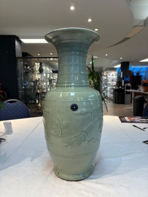 A Chinese celadon-glazed vase with relief lotus scroll design, 18th C. — photo 1