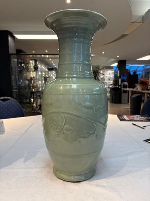 A Chinese celadon-glazed vase with relief lotus scroll design, 18th C. — photo 2