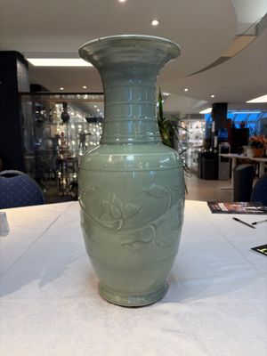 A Chinese celadon-glazed vase with relief lotus scroll design, 18th C. — photo 3