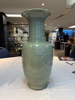 A Chinese celadon-glazed vase with relief lotus scroll design, 18th C. — photo 4