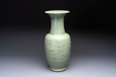 A Chinese celadon-glazed vase with relief lotus scroll design, 18th C.