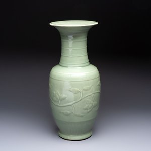 A Chinese celadon-glazed vase with relief lotus scroll design, 18th C. — photo 1