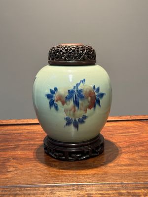 A Chinese celadon-ground blue, white and copper-red ginger jar with reticulated wooden cover and stand, 18th C. — photo 1