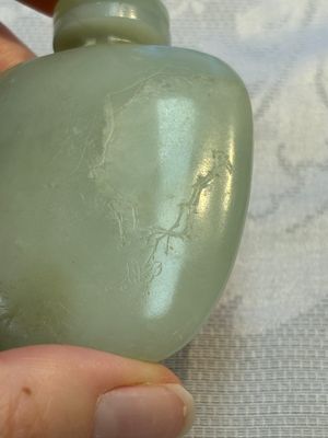A Chinese celadon jade snuff bottle, a plaque and a ritual stick, Han and later — photo 27