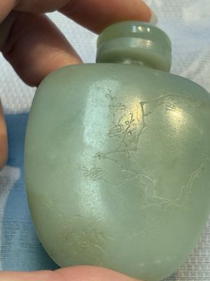 A Chinese celadon jade snuff bottle, a plaque and a ritual stick, Han and later — photo 28