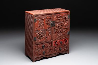 A Chinese cinnabar lacquer 'mountainous landscape' cabinet, 19th C.