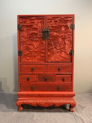 A Chinese cinnabar lacquer 'mountainous landscape' cabinet on a stand, 19th C. — photo 1
