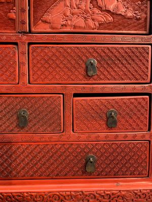 A Chinese cinnabar lacquer 'mountainous landscape' cabinet on a stand, 19th C. — photo 11