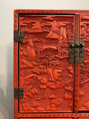 A Chinese cinnabar lacquer 'mountainous landscape' cabinet on a stand, 19th C. — photo 2