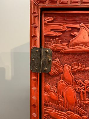 A Chinese cinnabar lacquer 'mountainous landscape' cabinet on a stand, 19th C. — photo 5