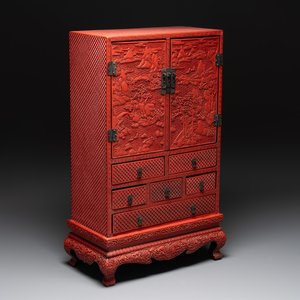A Chinese cinnabar lacquer 'mountainous landscape' cabinet on a stand, 19th C. — photo 1
